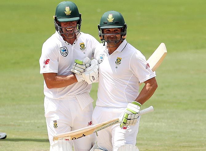 Dean Elgar, right, is congratulated by AB de Villiers after completing his half-century on Tuesday