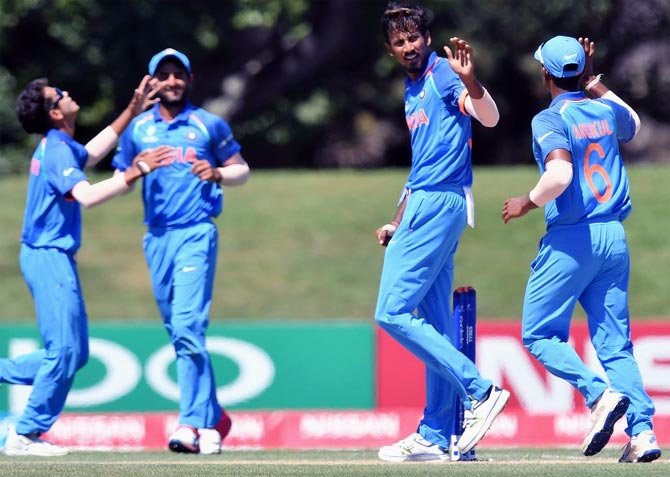 Ishan Porel, 2nd right, celebrates taking a wicket with his teammates
