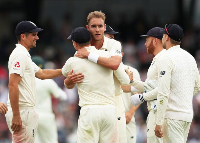 Stuart Broad celebrates a wicket with teammates