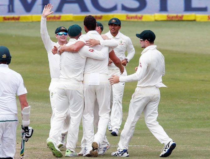 Australia players celebrate beating South Africa on Day 5 of the 1st Test on Durban