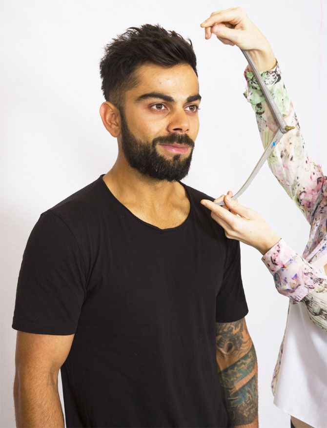 Virat Kohli's face is measured by a Madame Tussuads artist