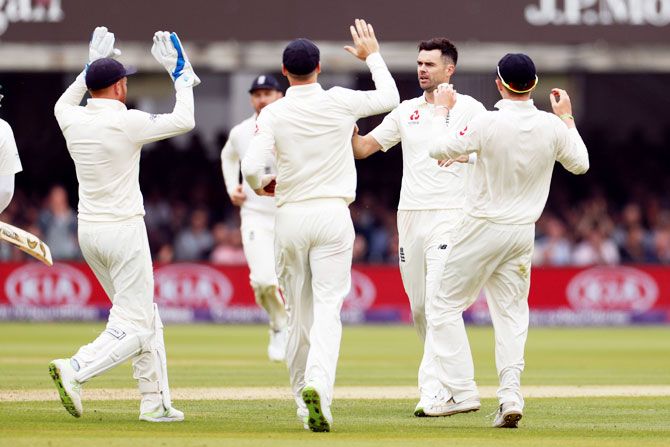 England's James Anderson celebrates with teammates after taking the wicket of Pakistan's Azhar Ali