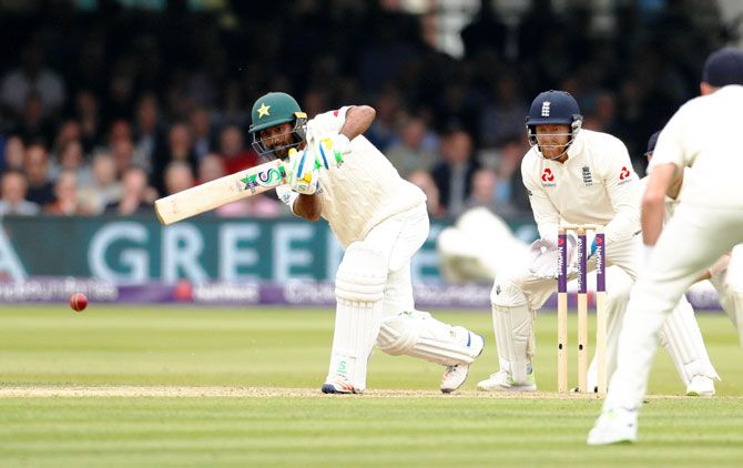 Pakistan's Asad Shafiq in action as England's Jonny Bairstow looks on