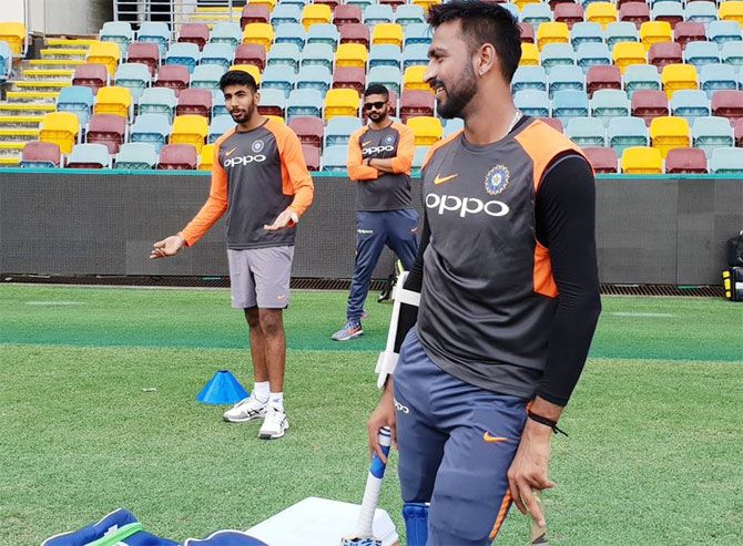 Krunal Pandya (right) and Jasprit Bumrah have a light moment at the nets