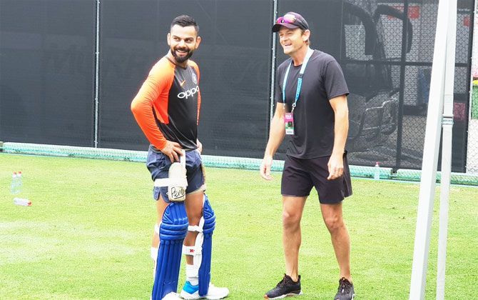 Former Australia keeper Adam Gilchrist drops in to have a chat with Virat Kohli during India's nets session on Tuesday