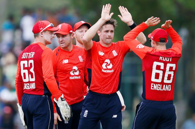 England's Chris Woakes celebrates with his teammates after taking the wicket of Sri Lanka's captain Dinesh Chandimal during the 2nd one-day international at Dambulla on Sunday