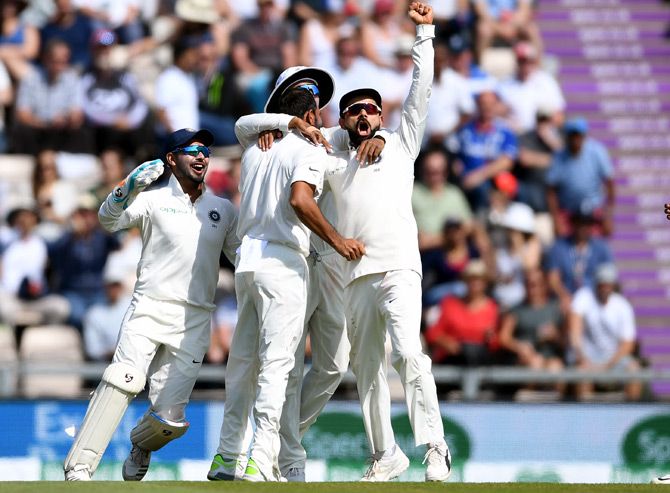 India's players celebrate the wicket of Jonny Bairstow in England's second innings on Day 3 on Saturday