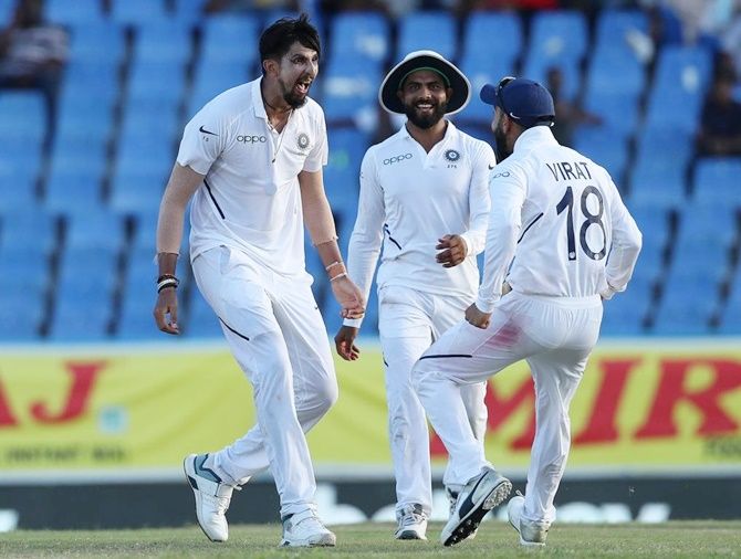 Ishant Sharma celebrates with skipper Virat Kohli and Ravindra Jadeja after dismissing Keemar Roach of the West Indies on Day 2 of the first Test, in Antigua, on Friday.