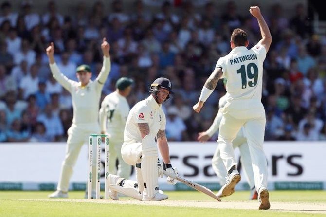 England's Ben Stokes reacts after losing his wicket even as Australia's James Pattinson celebrates.
