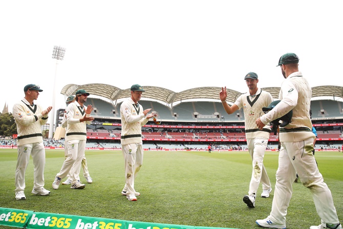 Australia pacer Mitchell Starc is applauded as he leaves the field after taking six wickets in the Pakistan first innings on Sunday, Day 3 of the second Test, at the Adelaide Oval.