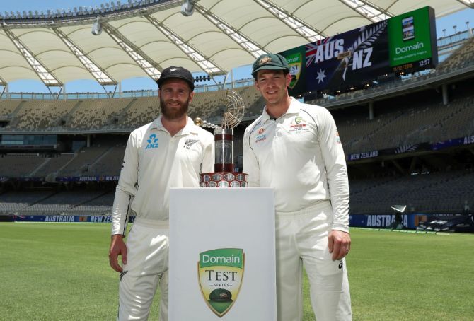New Zealand's Kane Williamson and Australia's Tim Paine pose with the Trans-Tasman trophy during a media opportunity ahead of the first Test at Optus Stadium in Perth on Wednesday