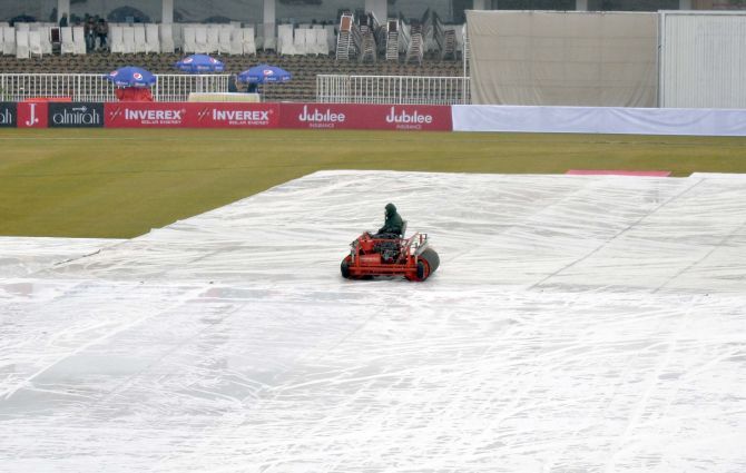 The covers stay on the pitch as rains lash the ground on Day 4 of the opening Test in Rawalpindi on Saturday