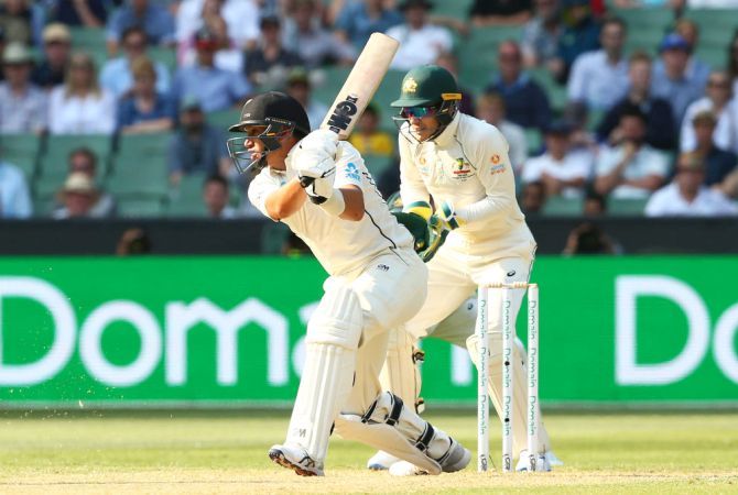 New Zealand's Ross Taylor bats as Australia captain and keeper Tim Paine looks on on Day 2 of the Boxing Day Test at MCG on Friday