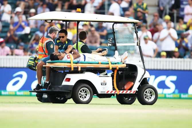 Sri Lanka's Dimuth Karunaratne is stretchered off the field after being struck by a delivery from Australia's Pat Cummins on Saturday