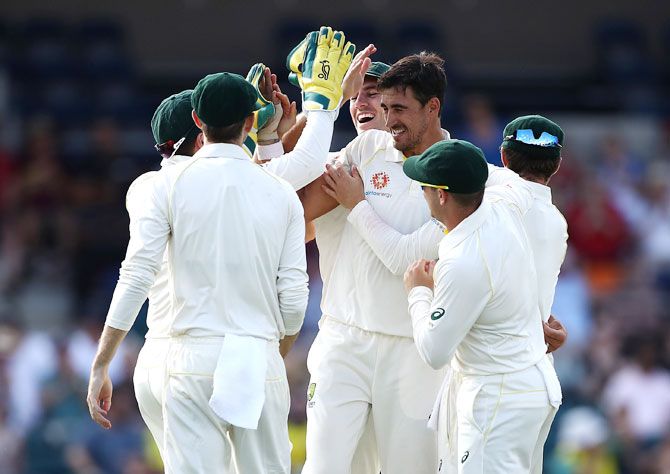 Mitchell Starc celebrates after taking the wicket of Dinesh Chandimal