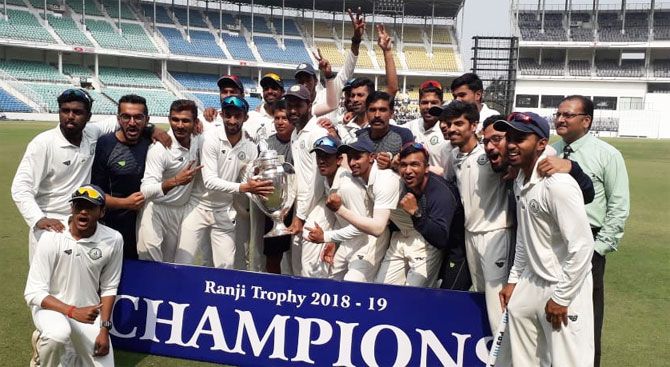 The Vidarbha cricket team celebrate with the trophy after winning the Ranji final on Thursday