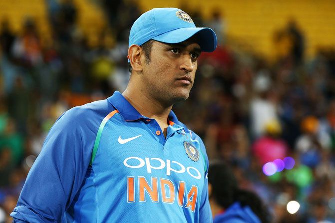 Dhoni's delirious fan, who was holding the tri-colour, breached the security and rushed towards the former Indian captain to touch his feet