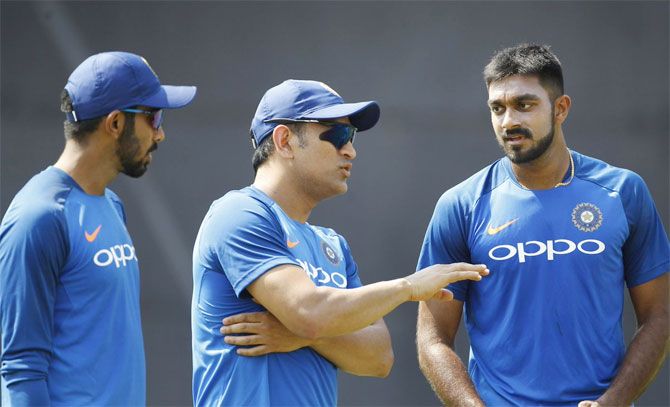 MS Dhoni chats with Vijay Shankar (right) and Jasprit Bumrah during a nets session on Saturday
