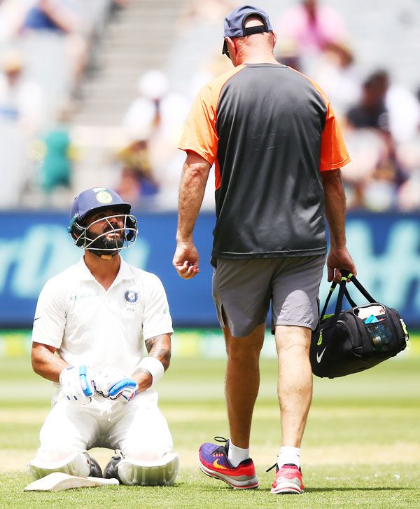 India's Virat Kohli seeks medical assistance during Day 2 of the third Test match against Australia at Melbourne Cricket Ground in Melbourne on Thursday
