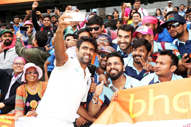 Ravichandran Ashwin celebrates with members of the Bharat Army after India's 2-1 series win on Monday