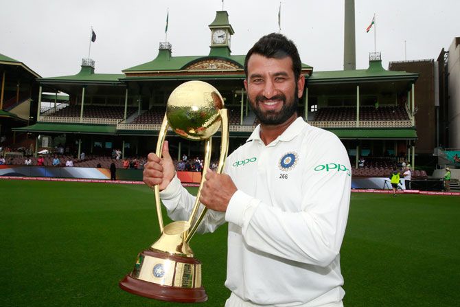 Man of the series, Cheteshwar Pujara celebrates with the trophy