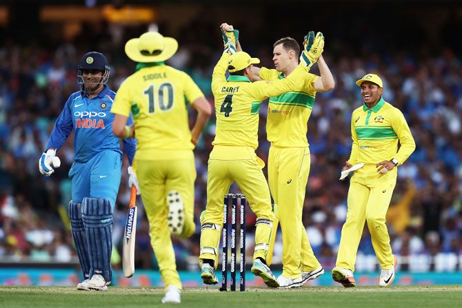 Debutant Jason Behrendorff celebrates with teammates after taking the wicket of MS Dhoni