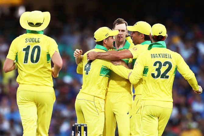 Australia's Jason Behrendorff celebrates with teammates after taking the wicket of MS Dhoni at Sydney Cricket Ground on Saturday