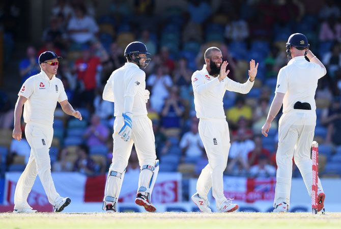 England's Moeen Ali celebrates after taking one of his three wickets to peg Windies back