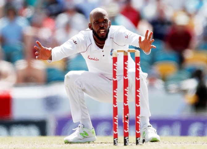 West Indies' Roston Chase celebrates the wicket of England's Ben Stokes before it is overturned and given not out 