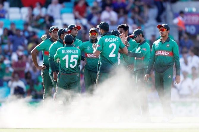 Bangladesh players celebrate the fall of a wicket