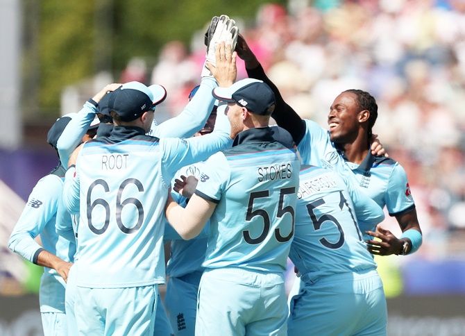 England's players celebrate the fall of a wicket at the World Cup.