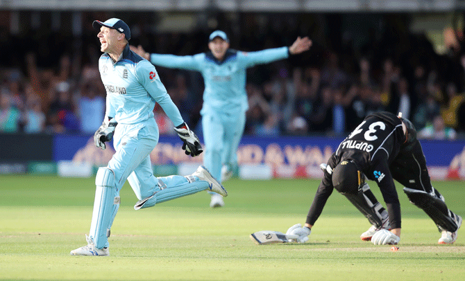 England's Jos Buttler runs out New Zealand's Martin Guptill during the Super Over to win the World Cup on boundary count 