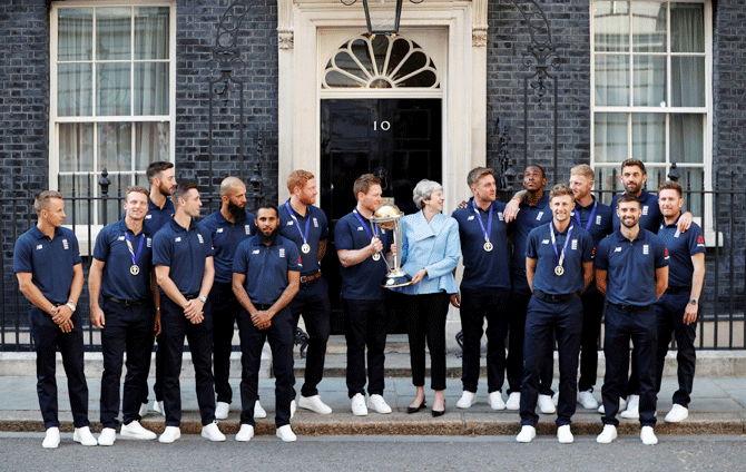 England's Eoin Morgan and Britain's Prime Minister Theresa May with the trophy as they pose with the team outside number 10