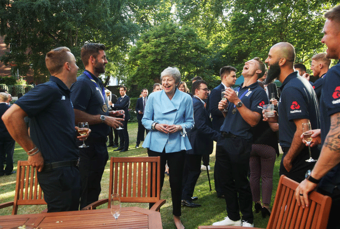 Members of the England Cricket Team including Liam Plunkett (2nd from left), Jason Roy (extreme right), Moeen Ali (2nd from right), Jos Buttler (3rd from right) share a laugh with Prime Minister Theresa May during a reception at 10 Downing Street on Monday