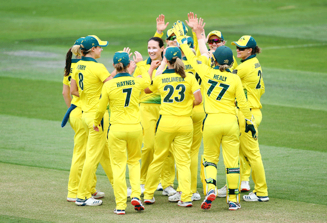 Australia's Megan Schutt celebrates with her teammates after dismissing England's Lauren Winfield during the 2nd Vitality Women's IT20 at The 1st Central County Ground in Hove, England, on Sunday