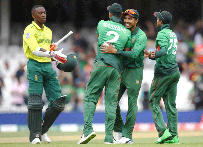 Bangladesh's Soumya Sarkar (centre) Shakib Al Hasan of Bangladesh (right) and Masrafe Mortaza celebrate as South Afric's Kagiso Rabada congratulates them after their win at The Oval in London on Sunday