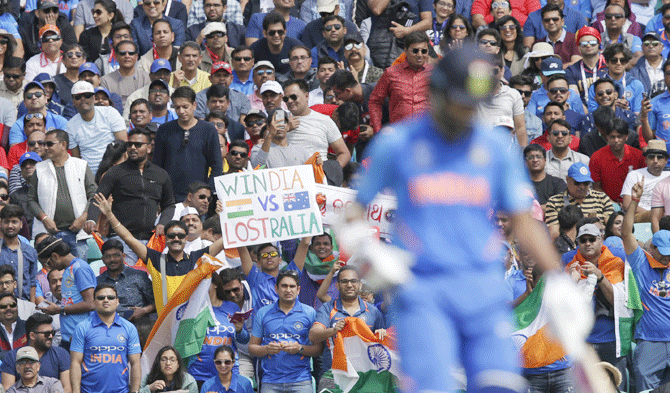 Indian fans hold up a cheeky placard during the ICC World Cup group stage match between India and Australia on Sunday