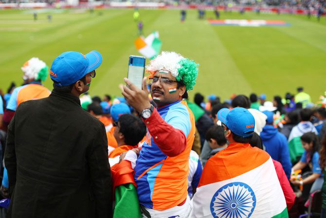 An India supporter takes a selfie ahead of the big match