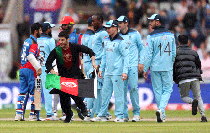 A pitch invader runs onto the field with an Afghanistan flag at the end of the England-Afghanistan on Tuesday 