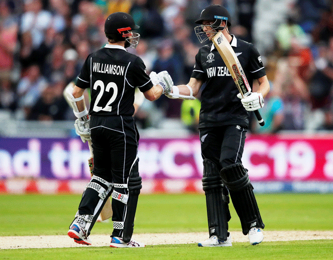 New Zealand's Kane Williamson celebrates with Mitchell Santner after defeating South Africa at Edgbaston on Wednesday
