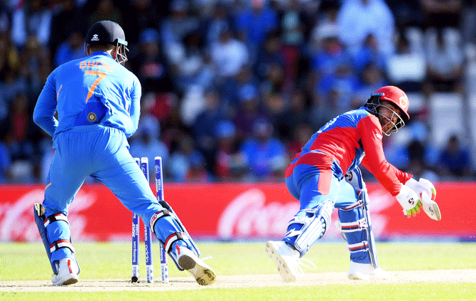 Rashid Khan is stumped by Mahendra Singh Dhoni off the bowling of Yuzvendra Chahal