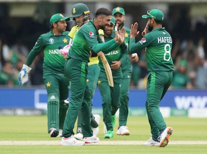 Mohammad Amir celebrates taking the wicket of Faf du Plessis with teammates.