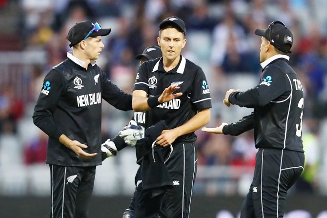 New Zealand's Trent Boult, center,  is congratulated by Mitchell Santner, left, and Ross Taylor 