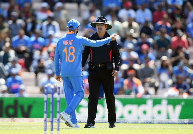 India skipper Virat Kohli speaks with umpire Richard Illingworth after an unsuccessful review during the World Cup match against Afghanistan at The Hampshire Bowl, in Southampton, on Saturday.