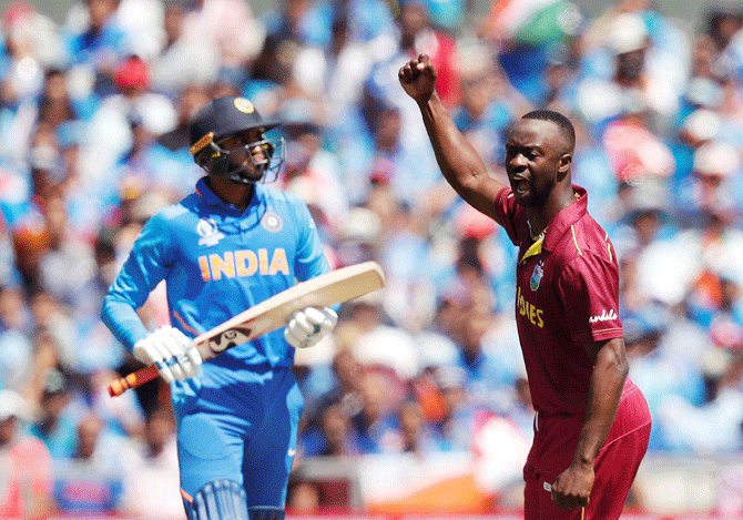 West Indies' Kemar Roach celebrates taking the wicket of India's Vijay Shankar on Thursday
