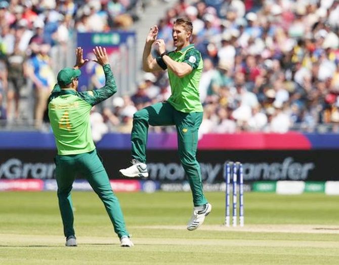 South Africa's Dwaine Pretorius, right, celebrates taking the wicket of Sri Lanka's Kusal Mendis in Friday's World Cup match at Chester-Le-Street.