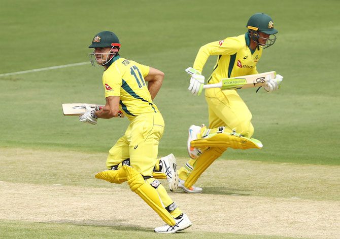 Australia's Marcus Stoinis and Usman Khawaja run between the wickets while stitching up a 87-run partnership