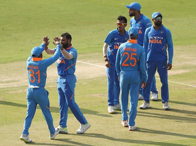 India's Mohammed Shami celebrates with teammates after taking the wicket of Australia's Glenn Maxwell
