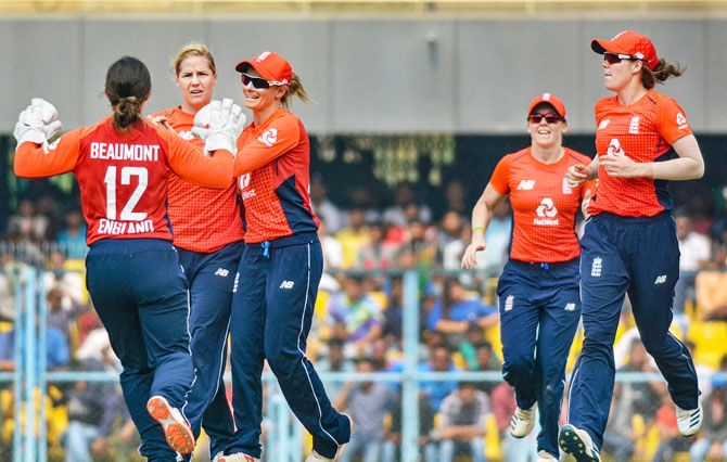 England's players celebrate the fall of an Indian wicket during the first T20 cricket International match, in Guwahati on Monday
