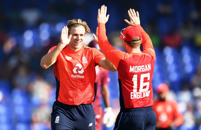 England's David Willey celebrates with captain Eoin Morgan after dismissing West Indies' Shimron Hetmyer during the 3rd Twenty20 International at Warner Park in Basseterre, St Kitts, Saint Kitts and Nevis, on Sunday